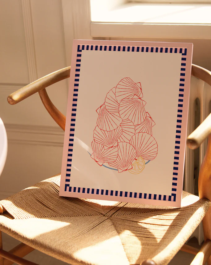The Saint-Jacques du Marché Poster features abstract red and yellow floral shapes created with a collage technique, bordered by a blue and pink geometric pattern, resting on a wooden chair where sunlight from a nearby window casts gentle shadows.