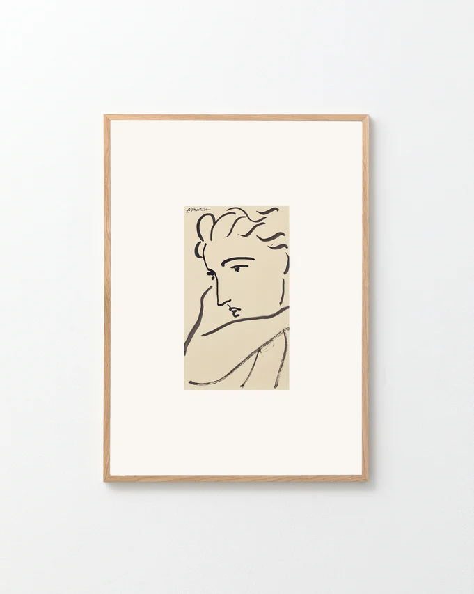 Framed line drawing of a woman's face on a white background