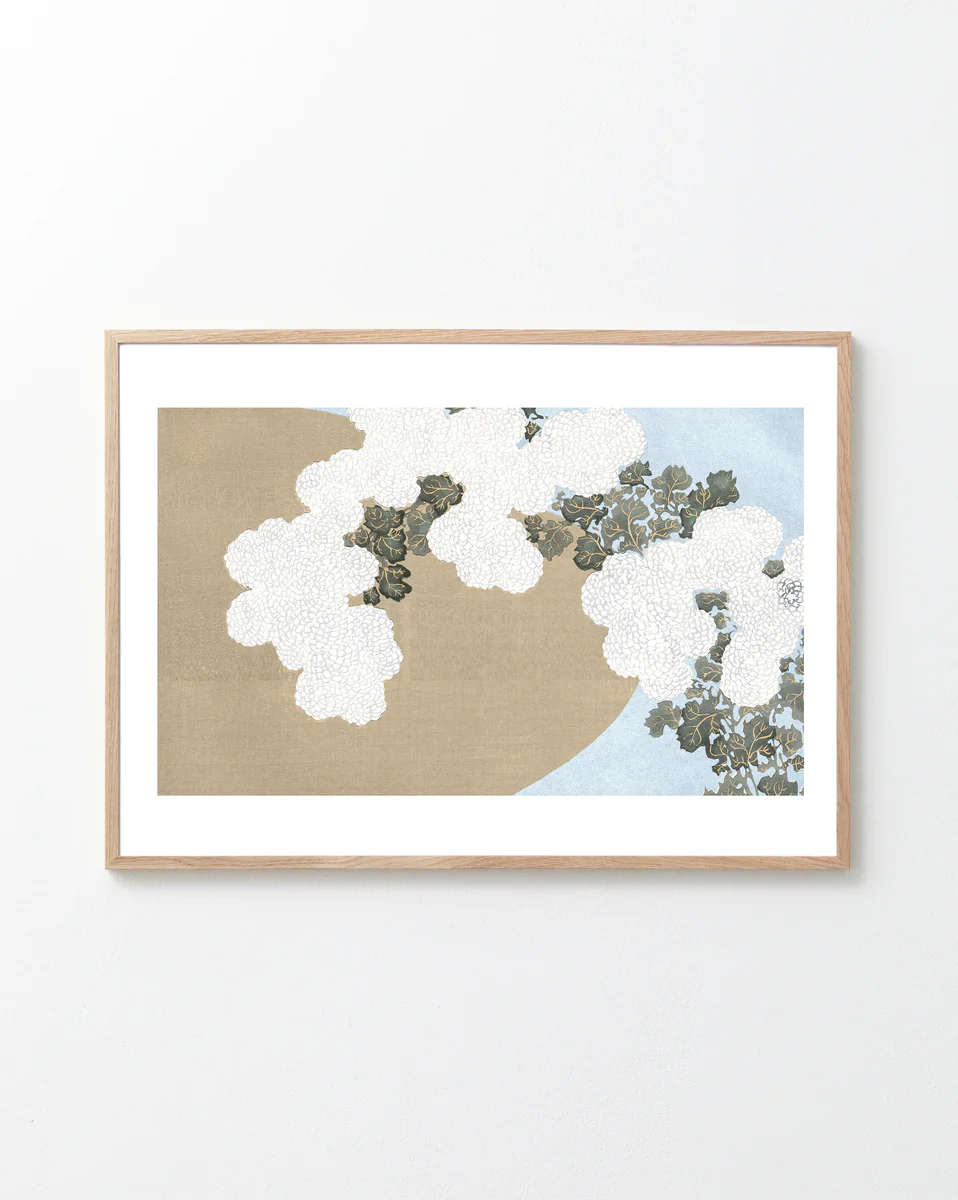 Framed artwork with white flowers on a beige and blue background