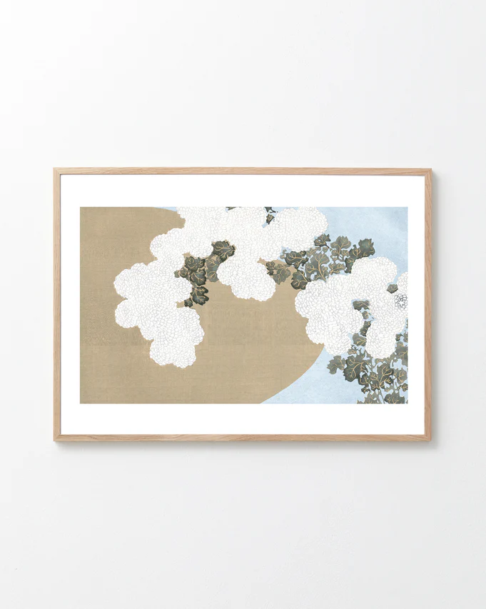 Framed artwork with white flowers on a beige and blue background