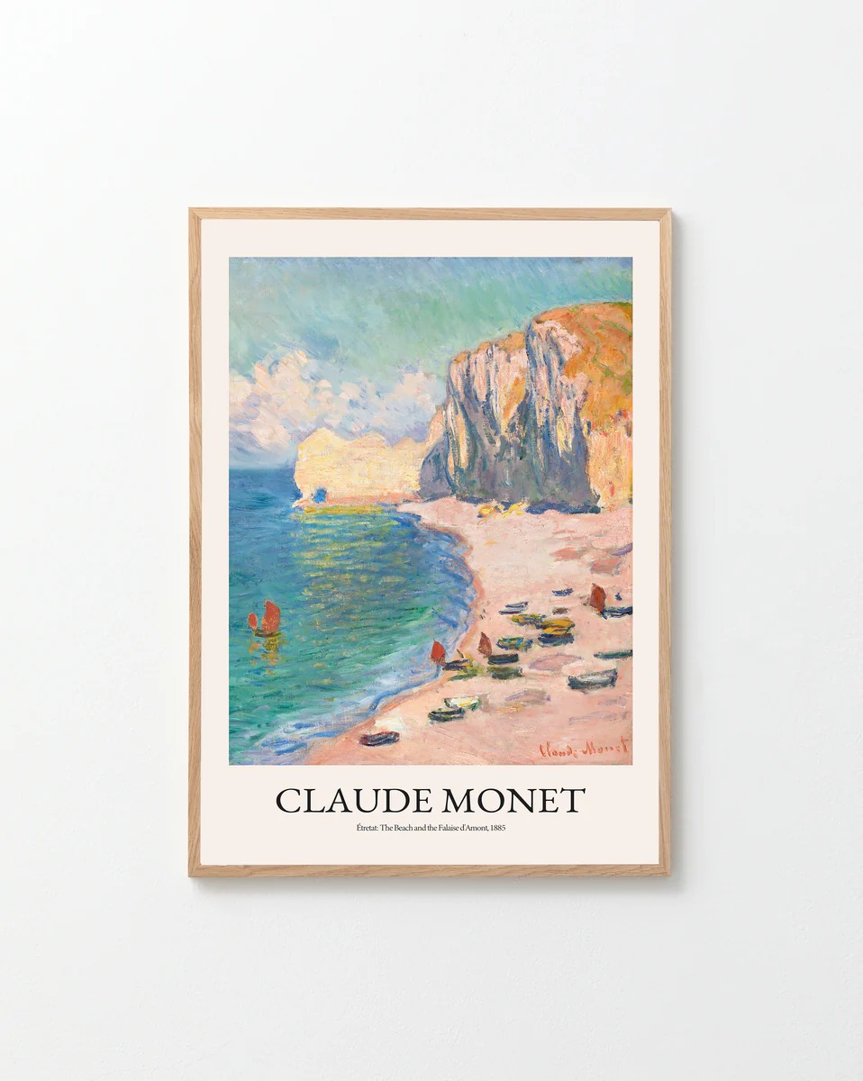 Framed Étretat: The Beach and the Falaise dAmont by Claude Monet, 1885 poster captures a French seascape with cliffs, beach, boats, and figures. Signed in red by Monet.