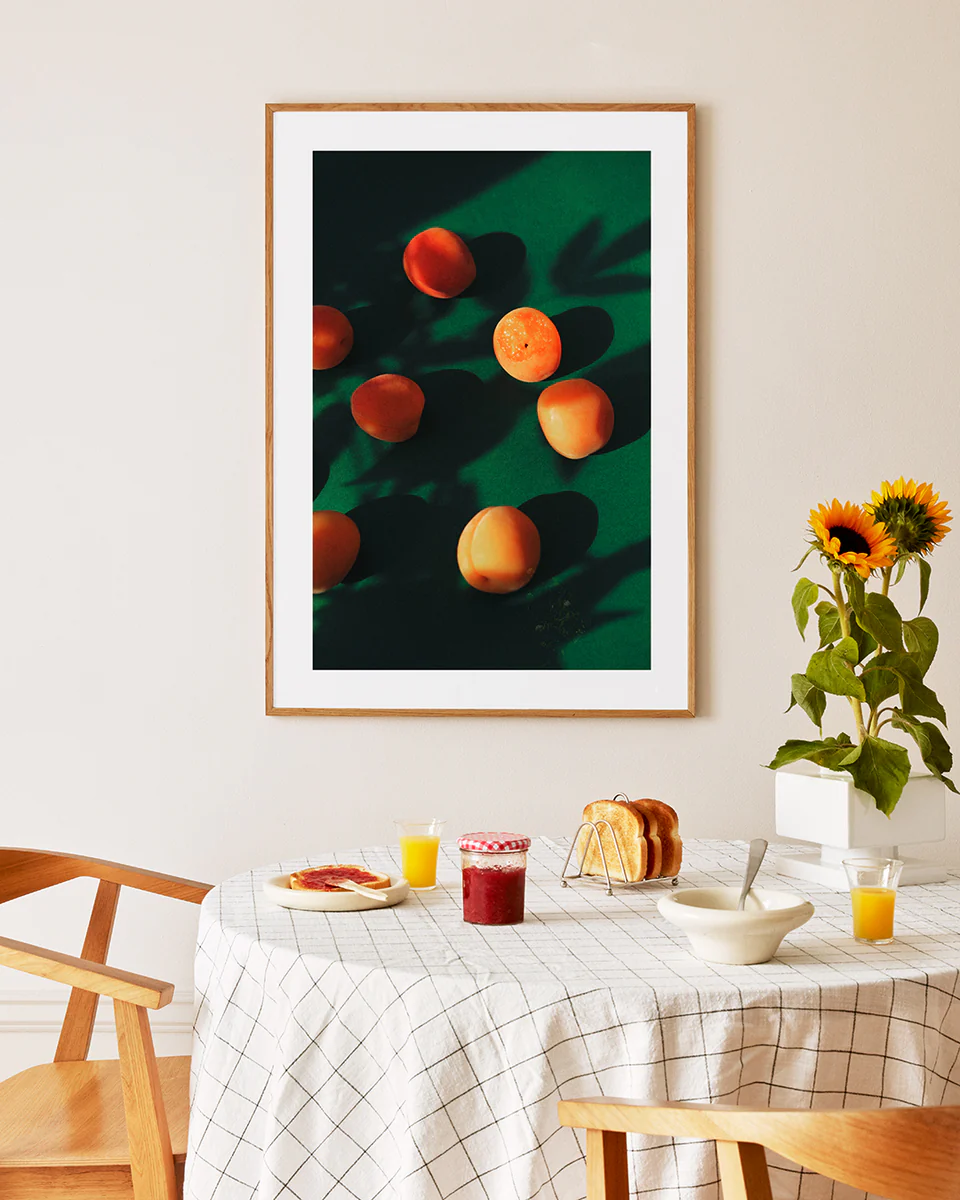 Poster framed in oak above a breakfast table