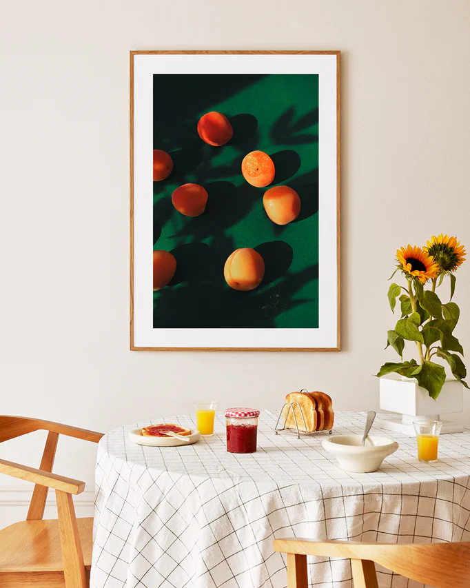 Poster framed in oak above a breakfast table