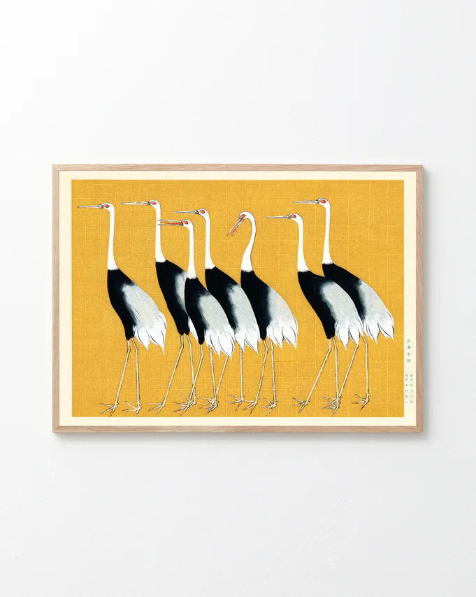The Japanese Red Crown Cranes by Ogata Korin poster features six elegant birds in Japanese style, standing left against a textured yellow background. These cranes with black, white, and red markings are framed in light wood, creating a stunning wall decoration.