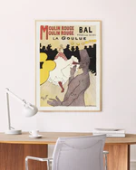 The La Goulue by Henri de Toulouse-Lautrec Poster showcases Parisian elegance, featuring stylized illustrations and dancers in yellow and white. It graces a white wall above a sleek desk with a modern lamp and cup.
