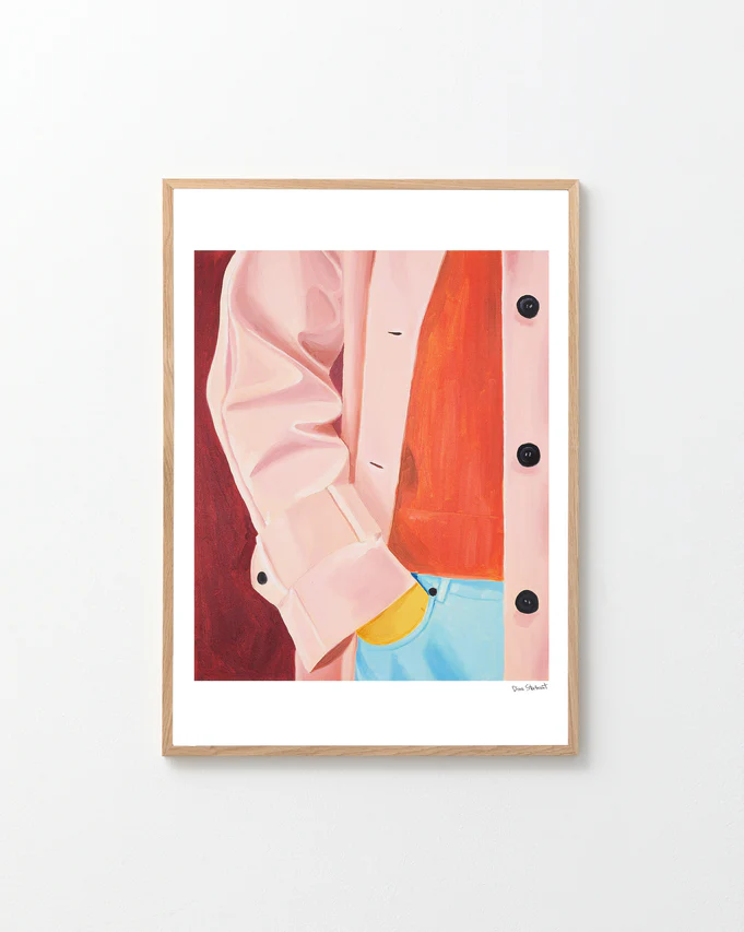 Framed artwork of a pink jacket and blue jeans against a red background.