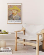 Framed Vincent Van Gogh artwork above a modern chair in a minimalistic room.