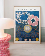 Framed Hilma af Klint artwork on a wall with a lamp and decorative table in the foreground.