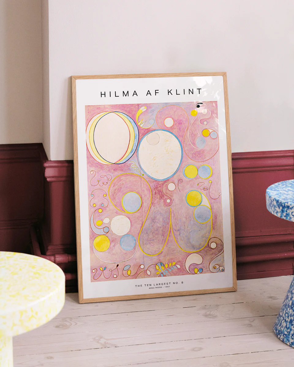 Framed Hilma af Klint artwork on a wall with decorative elements.