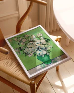 Framed artwork of a floral design on a wooden chair.