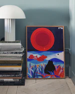 Poster leaning against a blue wall. On the left side there is a sideboard built of magazines and on top of the sideboard a white lamp