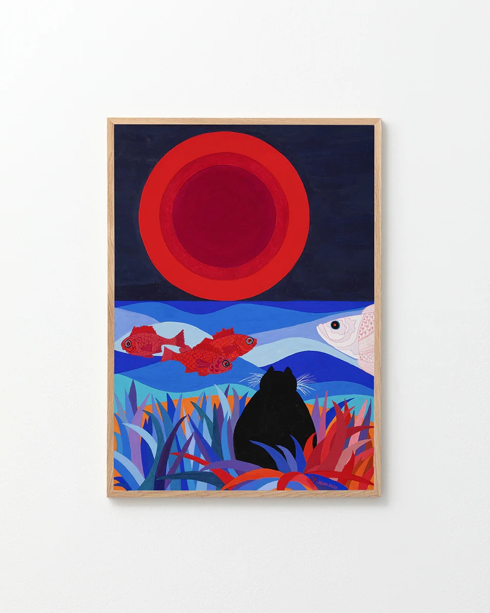 Oakframe with a poster featuring a artwork that shows a cat on a beach looking at the moon. It features vibrant blue hues, red fish, grasses, and a large moon, with a graphic design style like a silk screen print. Jean added a touch of humor, saying, "It looks like the cat is watching his dinner."