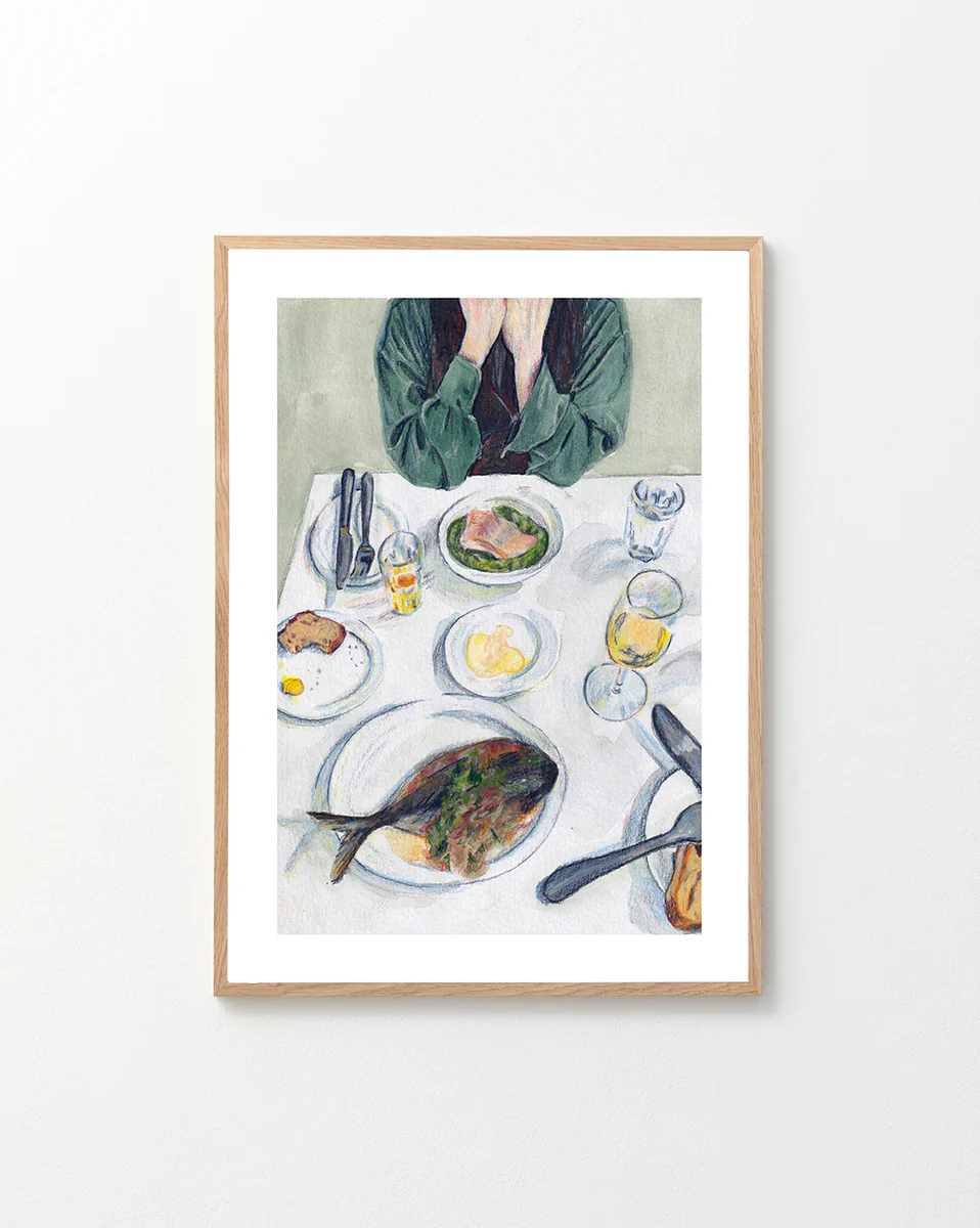 Poster "A Very Good Lunch" in a oakframe against a white wall