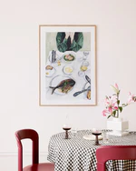 Poster  "A Very Good Lunch" in oak frame hanging above kitchen table