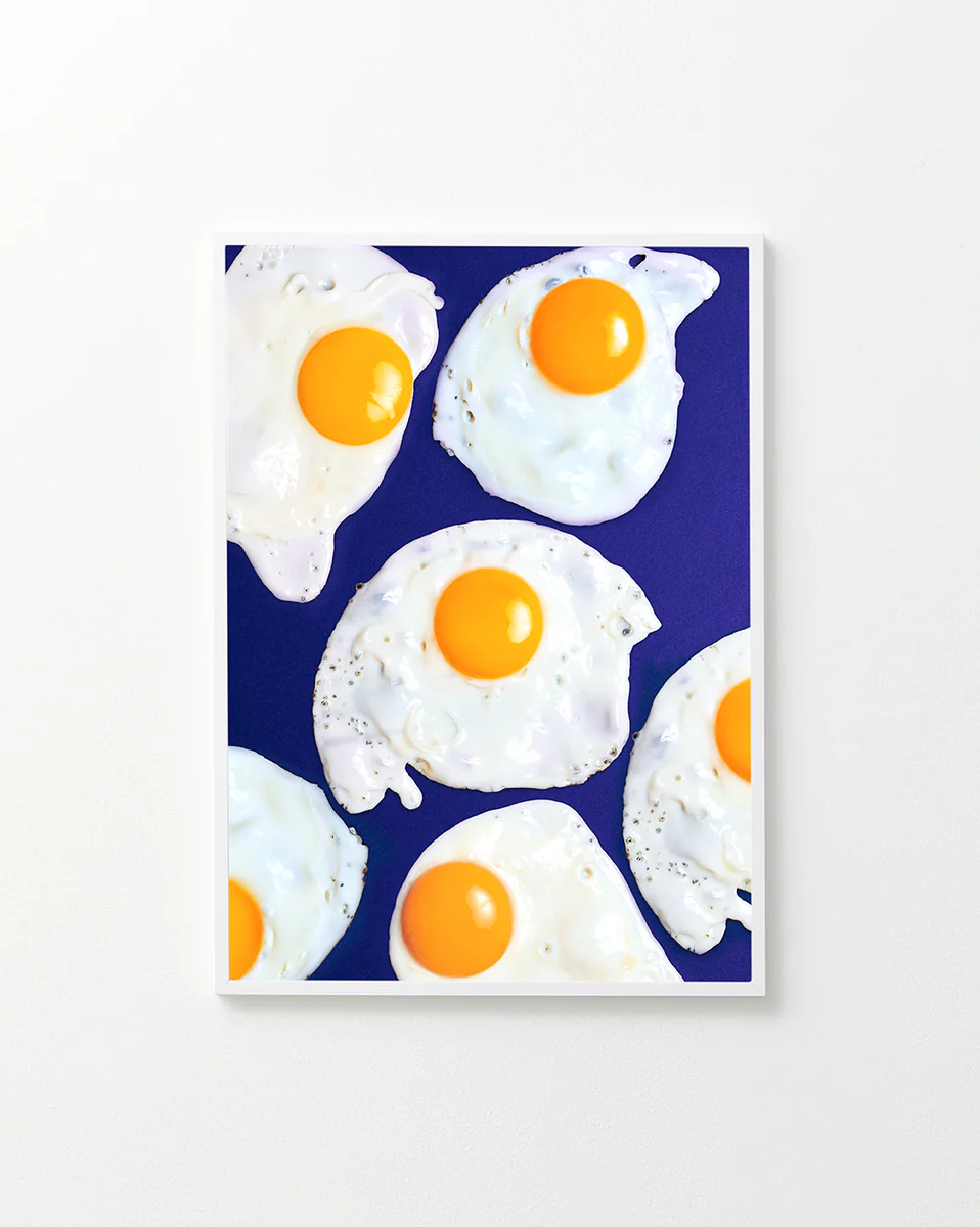 Poster "Eggs" in a white frame against a white background