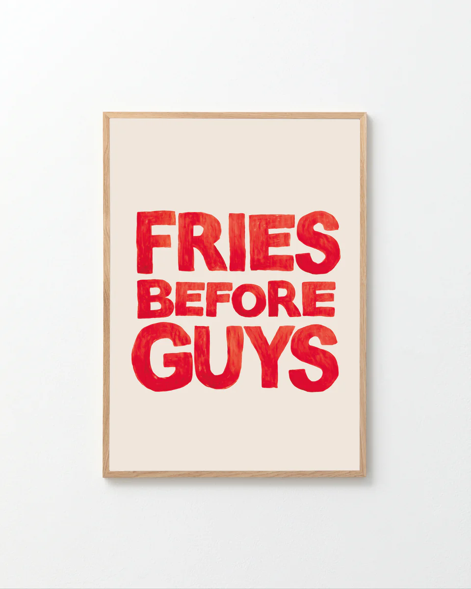 The Fries Before Guys poster is hand-painted, featuring bold red letters on a light beige background.