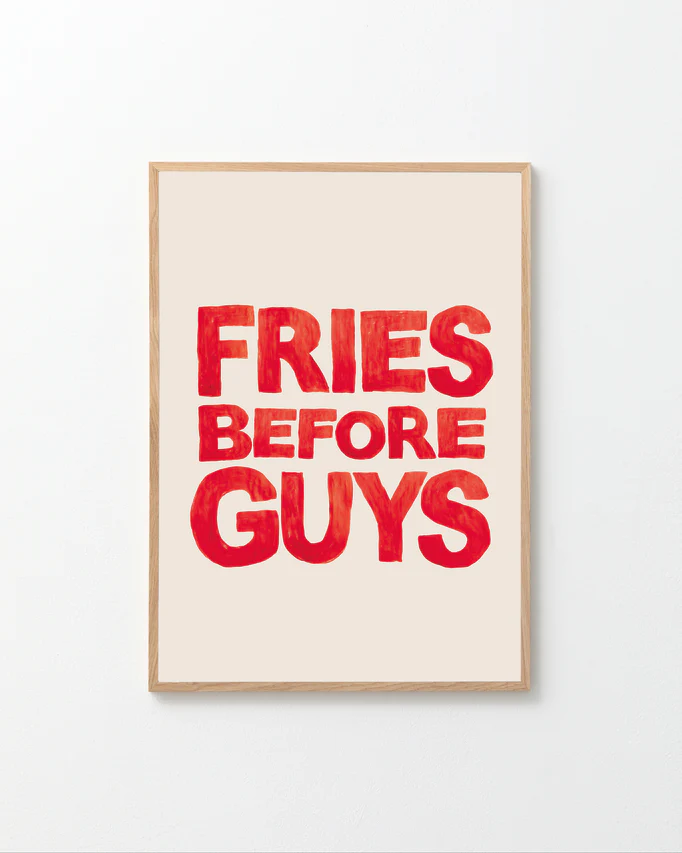 The Fries Before Guys poster is hand-painted, featuring bold red letters on a light beige background.