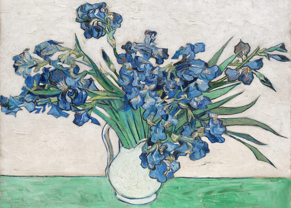 Painting of blue irises in a white pitcher on a table.