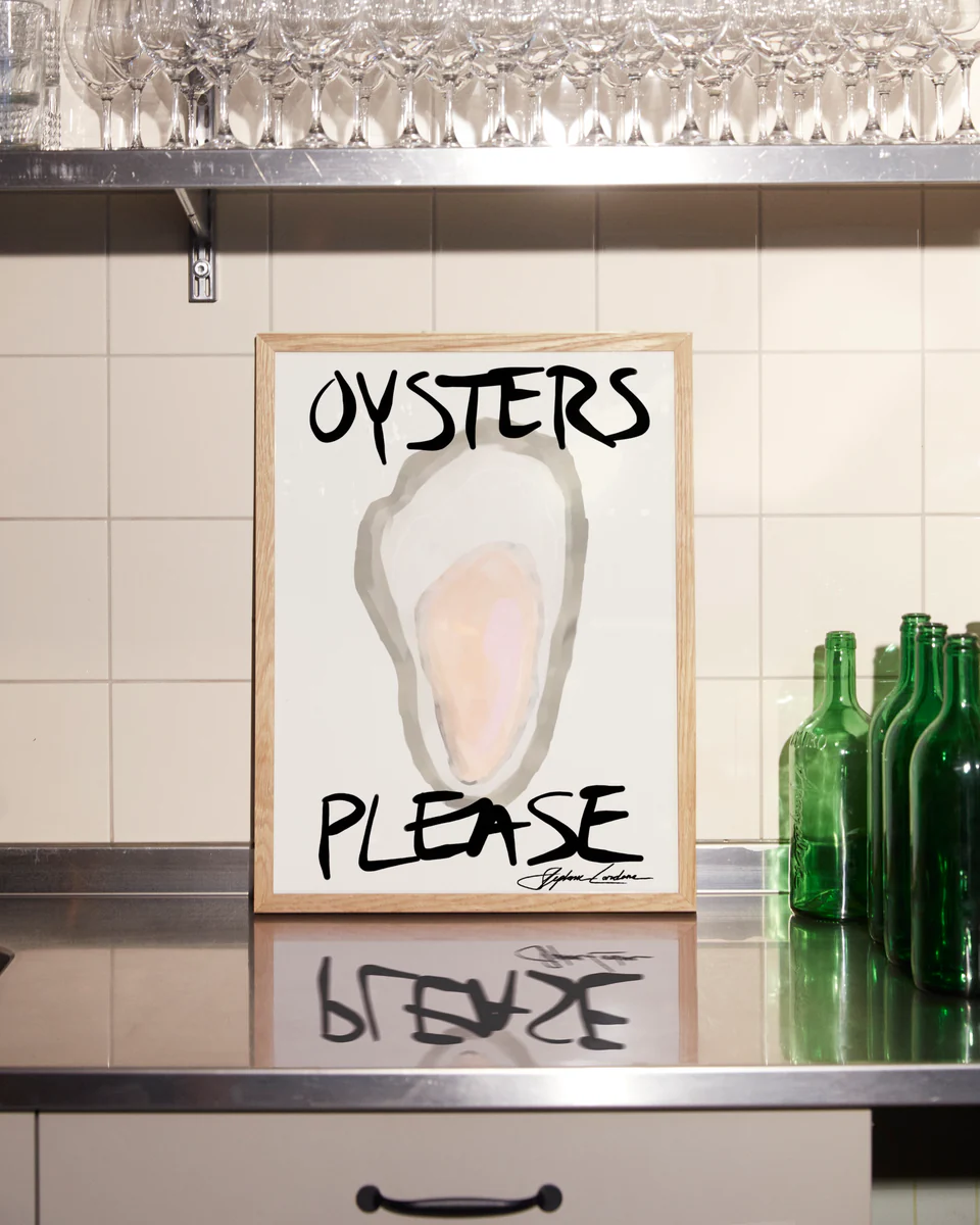 The framed Oysters Please Poster features a minimalistic digital design with bold black text, elegantly displayed on a stainless steel countertop against a tiled backsplash, surrounded by green bottles and glassware—ideal for seafood decor enthusiasts.