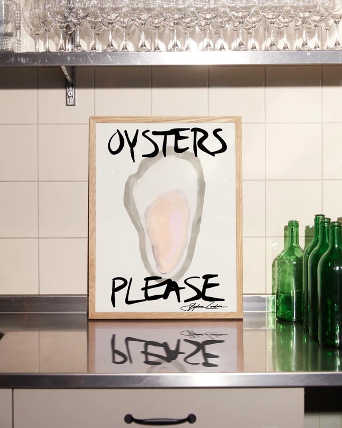 The framed Oysters Please Poster features a minimalistic digital design with bold black text, elegantly displayed on a stainless steel countertop against a tiled backsplash, surrounded by green bottles and glassware—ideal for seafood decor enthusiasts.