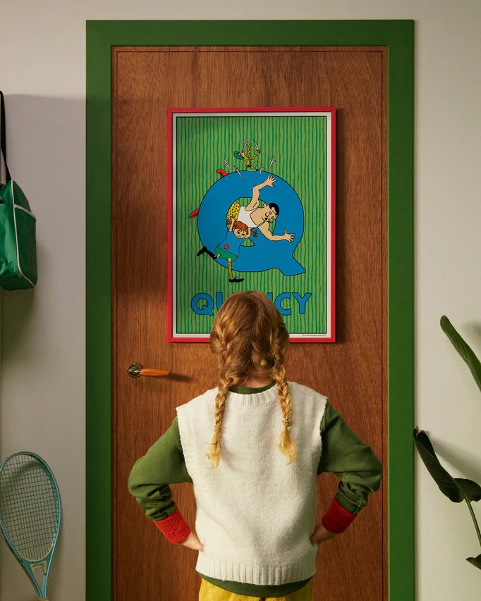 Pippi Longstocking personalised poster featuring the letter Q hanging on a door, with a child curiously looking at the artwork.