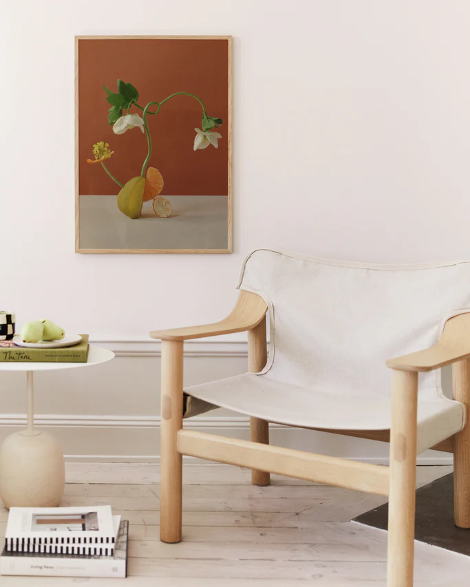 Poster featuring a stillife featuring a beautiful composition with flowers together with clementine in oak frame hanging in a livingroom