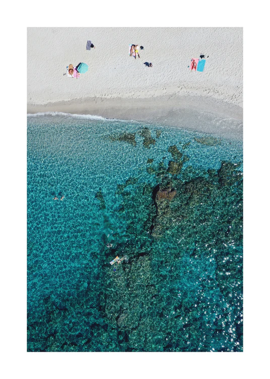 Drone photograph of a white sandbank and a turquoise ocean sparkling in the sun.