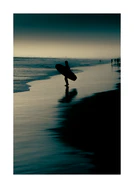 Surfer standing on the shore during low tide under a darkening sky.