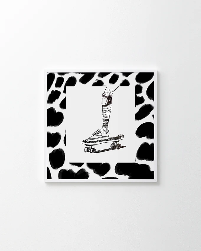 Skater wearing Vans and a kneepad framed in a black and white pattern.