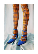 Legs wearing checkered mustard yellow stockings and high heeled blue sandals.