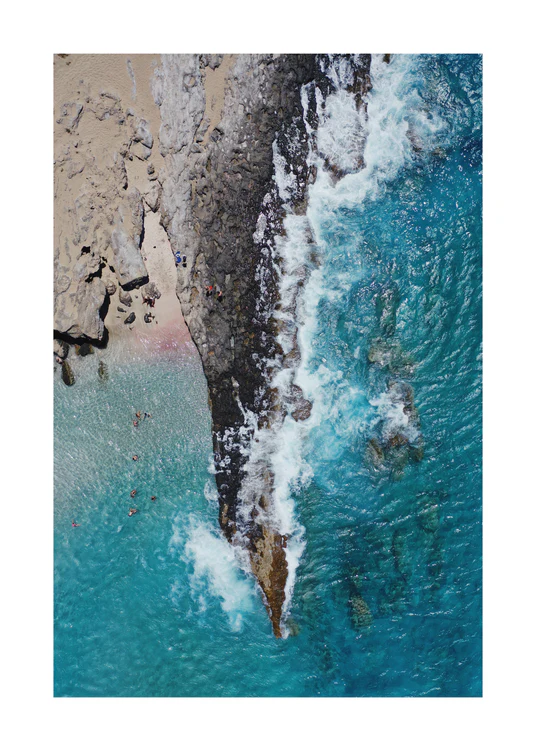 Cliff looking like a dagger cutting through a turquoise sea.