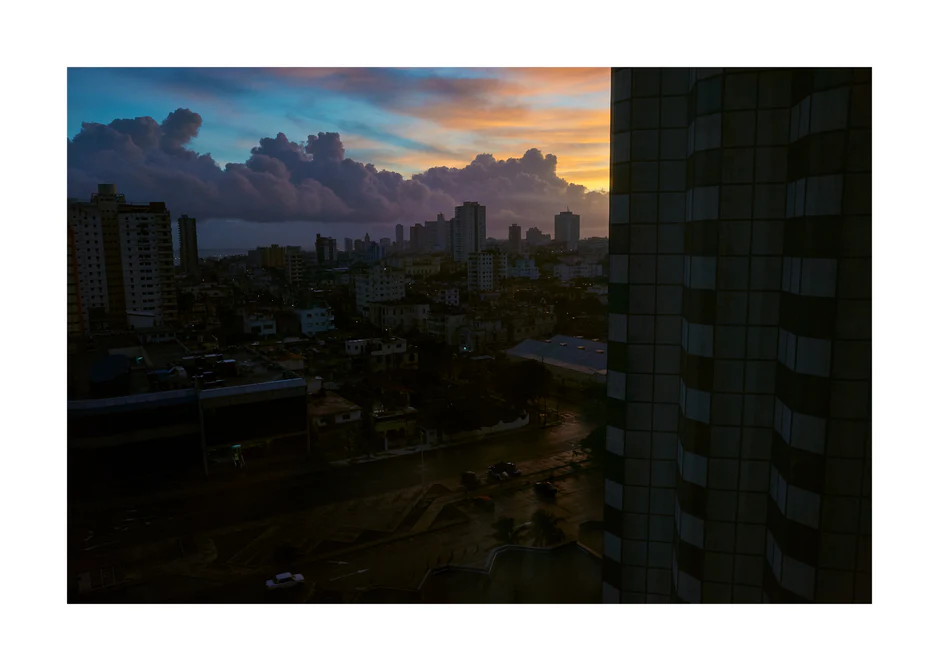 The Cuban capital Havana viewed from above under a sunset sky.