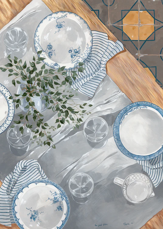 A wooden table set for four showcases The Good Plates Poster, featuring blue and white patterns, with striped napkins and clear glasses. A vase with a small plant sits in the center. The light grey tablecloth contrasts beautifully with the patterned floor, creating an elegant dining setting.