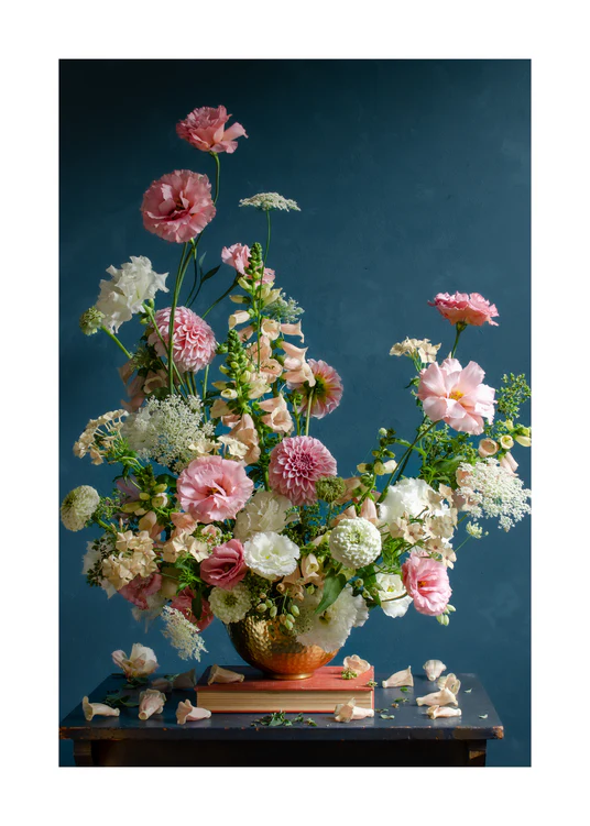 The Midsummer Poster features a lush bouquet of pink, white, and peach roses, peonies, and hydrangeas in a golden vase on a muted teal backdrop, with scattered petals atop a wooden table.