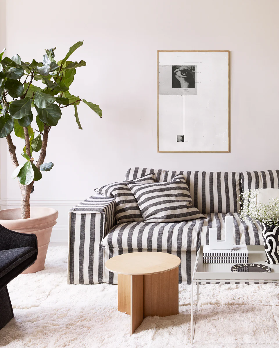 White canvas with two framed photographs in black and white and thin black lines.