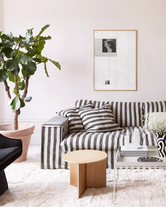 White canvas with two framed photographs in black and white and thin black lines.