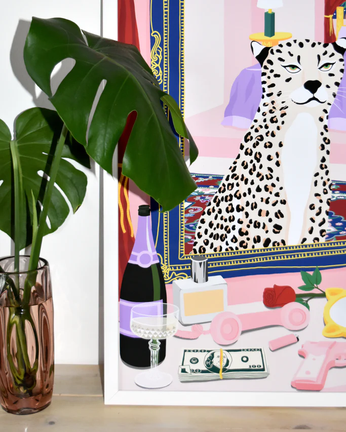 The Bonafyde Poster showcases a framed masterpiece featuring a leopard with a leafy plant. A champagne bottle, glass, dollar bill, lipstick, roses, and hand mirror adorn the table in front of the artwork.
