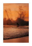 Surfer heading out into the orange waves during sunset.
