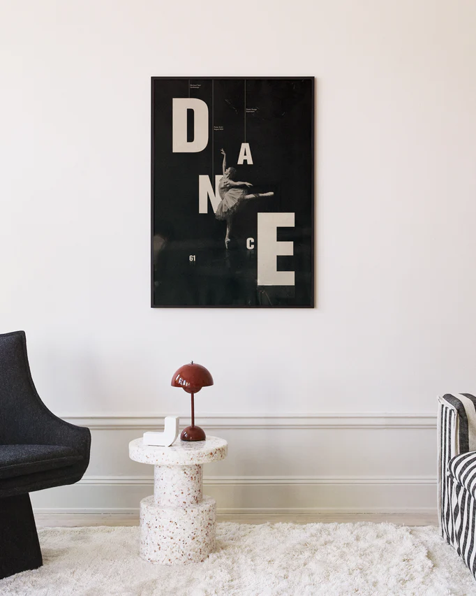 Ballerina on a black canvas surrounded by letters spelling out the word dance.