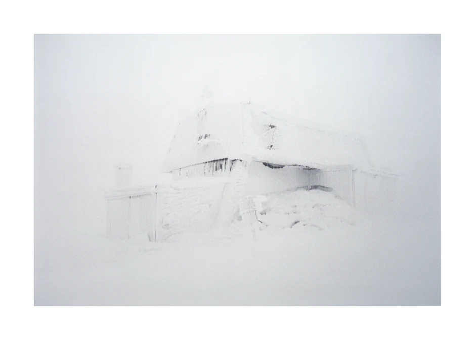 Weather station standing in a snowy white landscape where the wind is blowing.